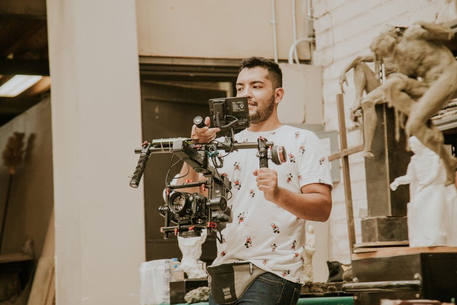 Professional wedding videographer filming a bride and groom